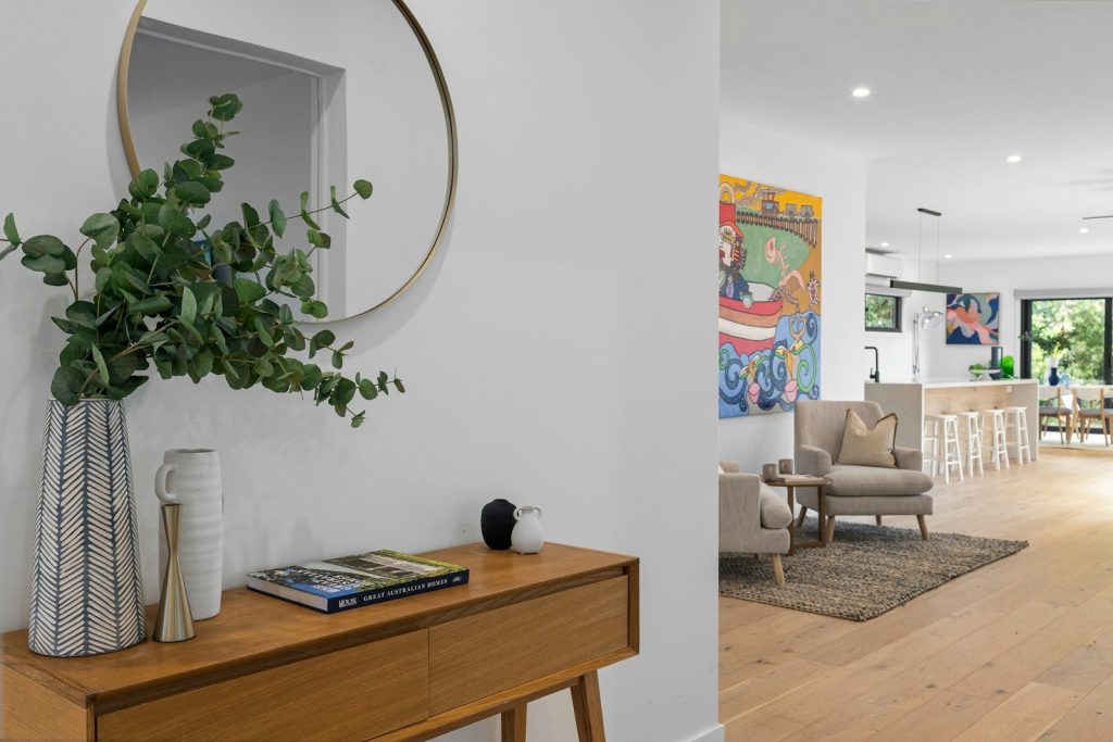 A living room filled with furniture and a large mirror
