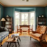 Teal living room with striped sofa and orange armchair