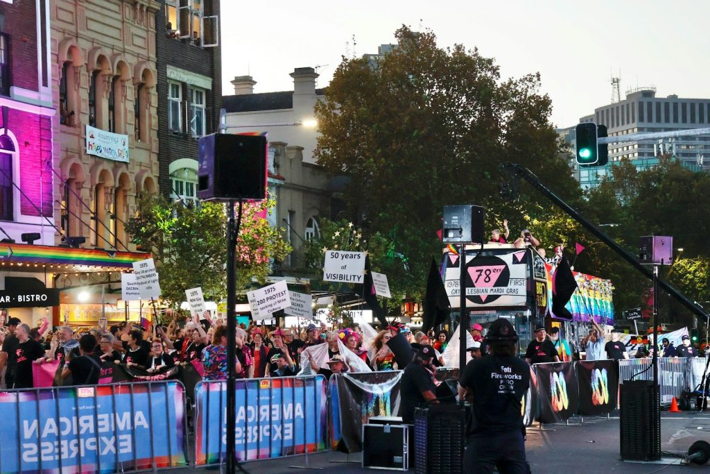 Crowd gathered for a parade or event with banners.