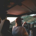 woman driving vehicle on road during daytime