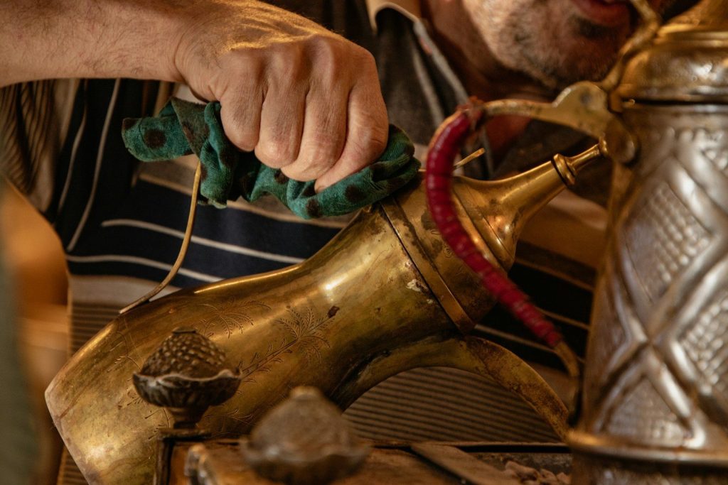 A man is pouring tea into a teapot