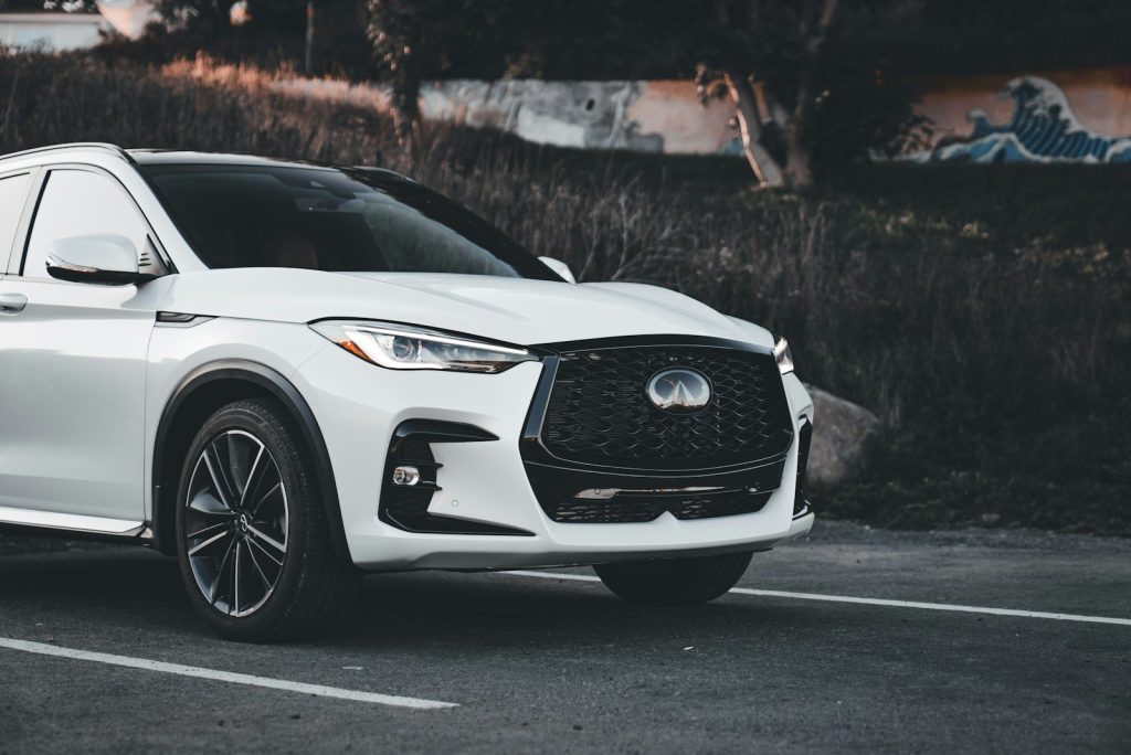 White luxury suv parked on asphalt road.