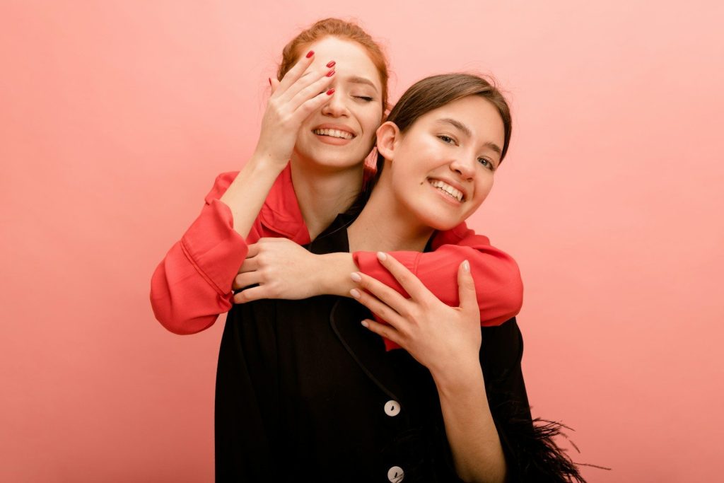 two women hugging each other and smiling