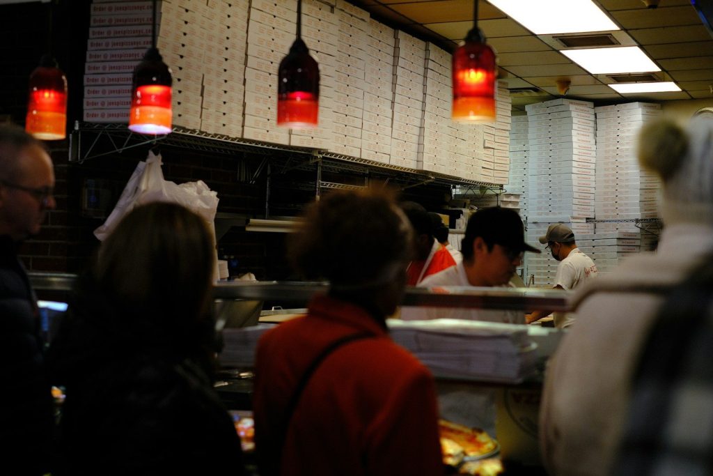 A group of people in a kitchen preparing food