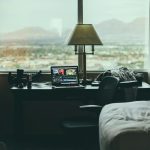 tabletop lamp beside laptop on desk beside window