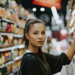 woman shopping in grocery store aisle