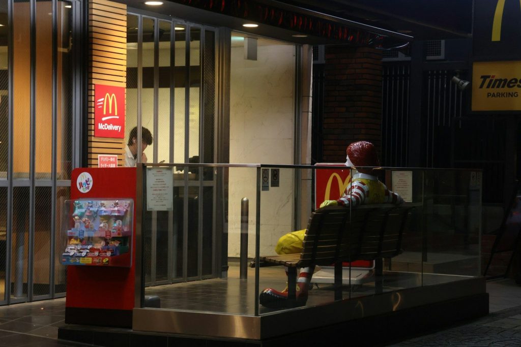 A person waits outside a closed mcdonald's.