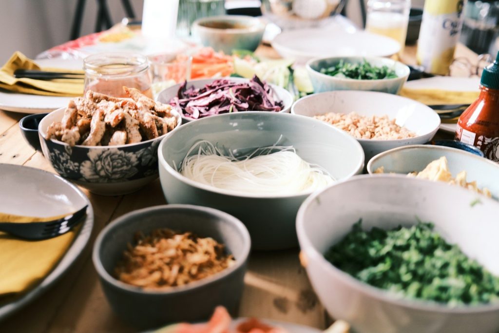 a bunch of bowls of food on a table