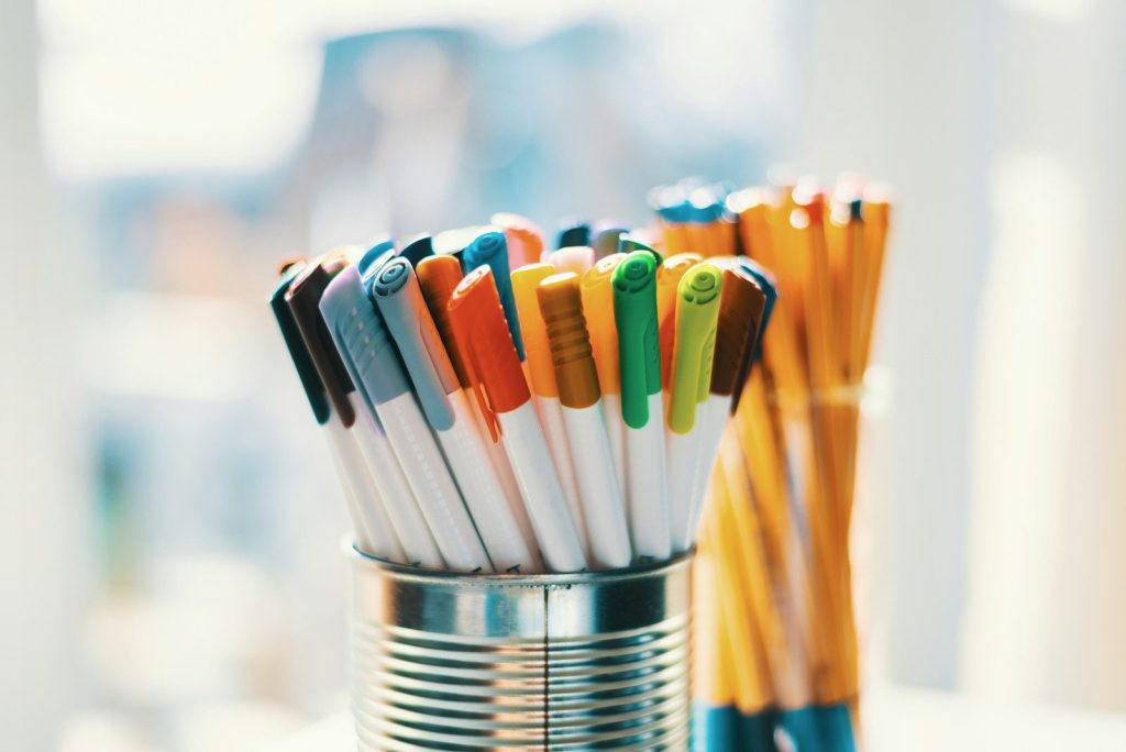 assorted color pen in silver container