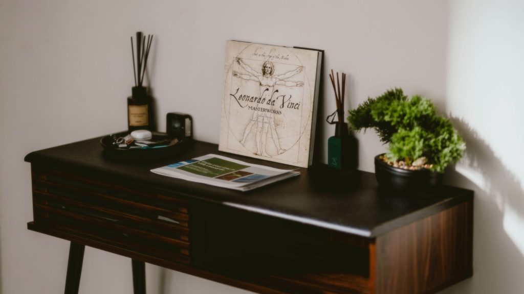 A table features books, plants, and scent diffusers.