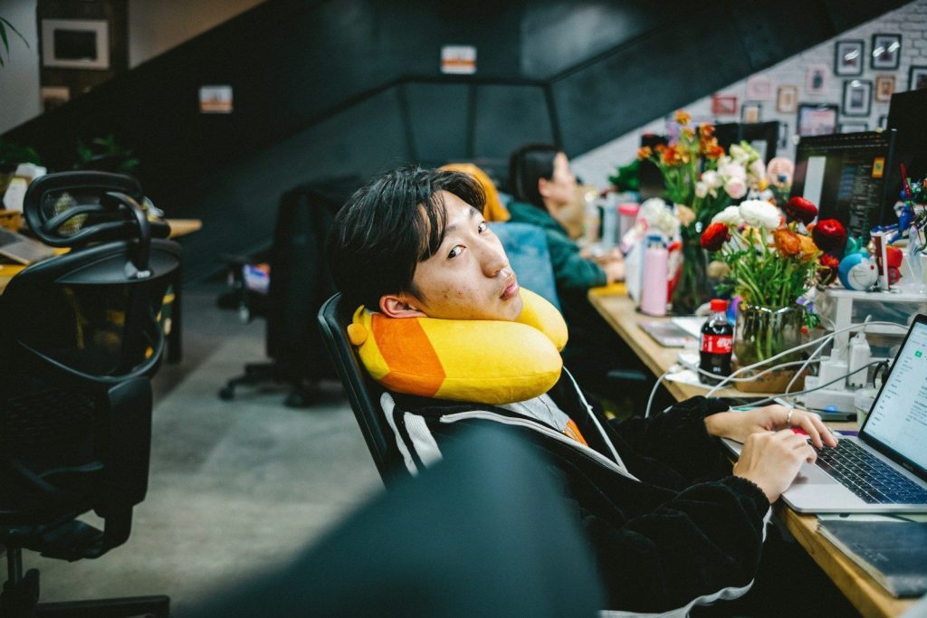 a person sitting at a desk with a laptop