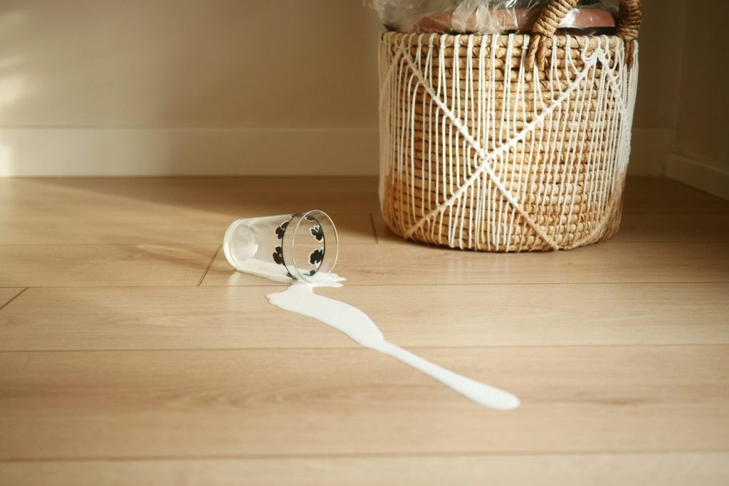 A basket with a toothbrush on a wooden floor