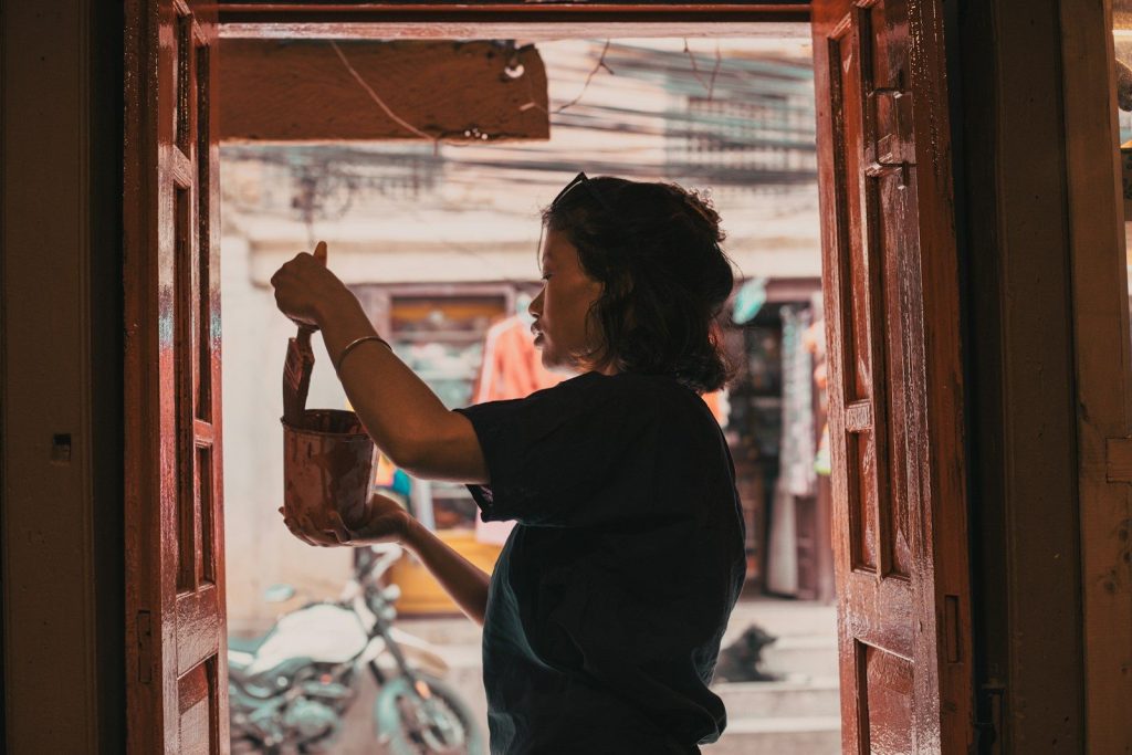 Woman holding a small leather bag indoors