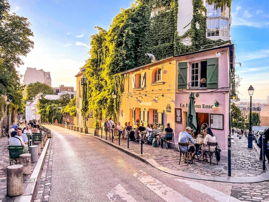 A charming street in paris with a cafe.