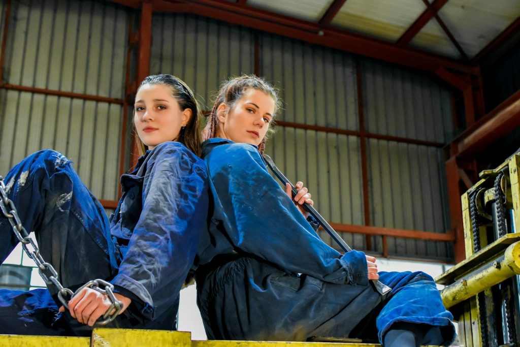 a couple of women sitting next to each other