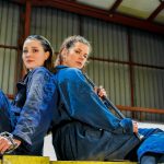 a couple of women sitting next to each other