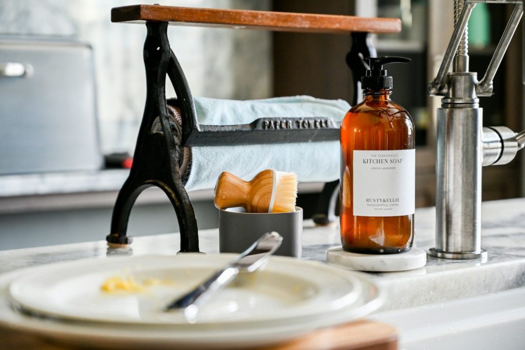 a bottle of liquid sitting on top of a sink