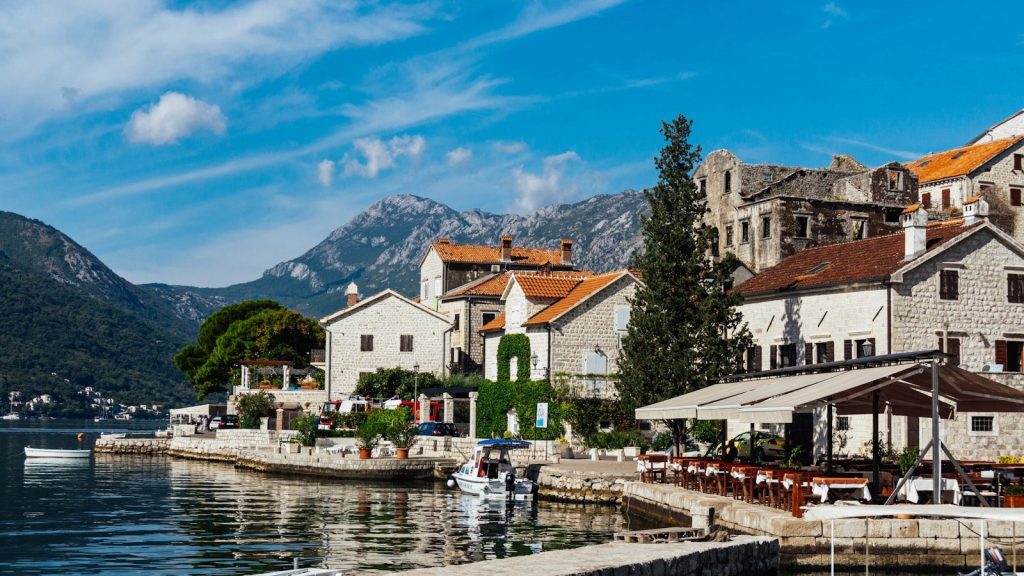 a group of buildings sitting next to a body of water