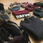 a pile of clothes sitting on top of a wooden floor