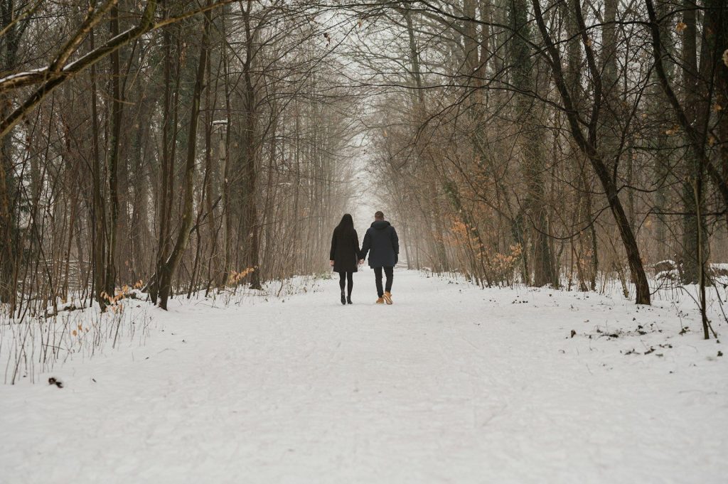 two people walking in the snow