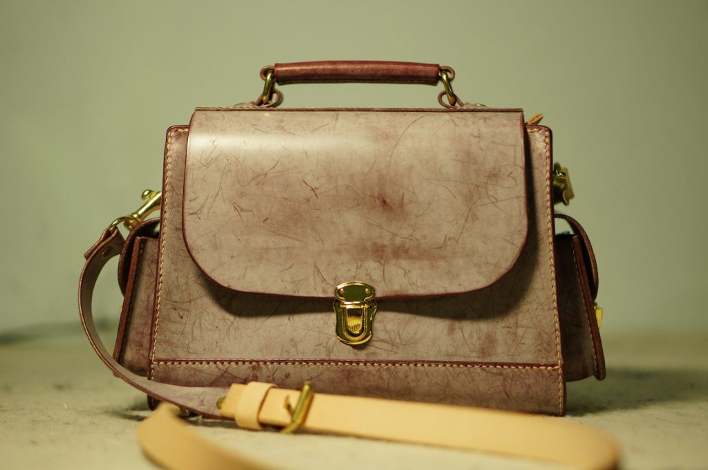 a brown purse sitting on top of a table