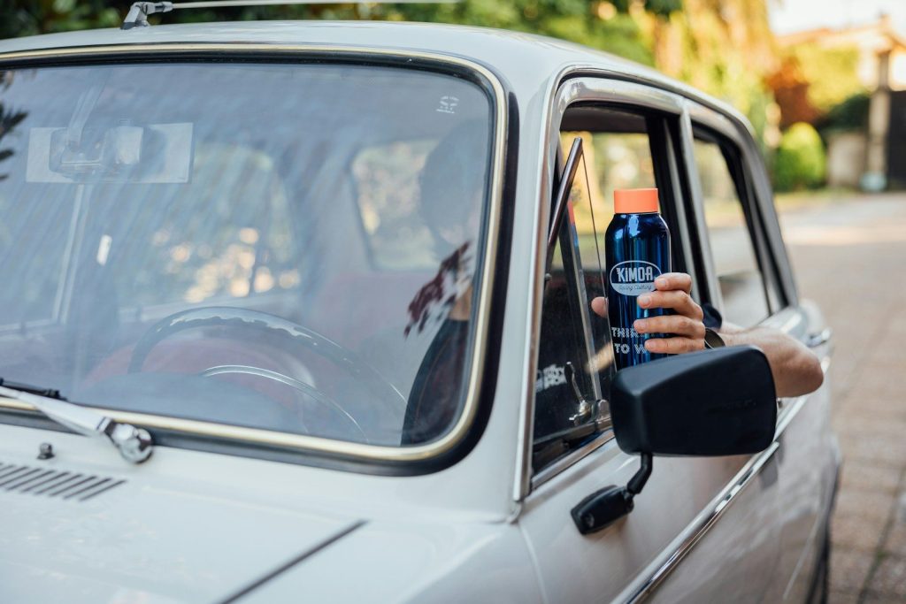 a person holding a bottle of water in a car