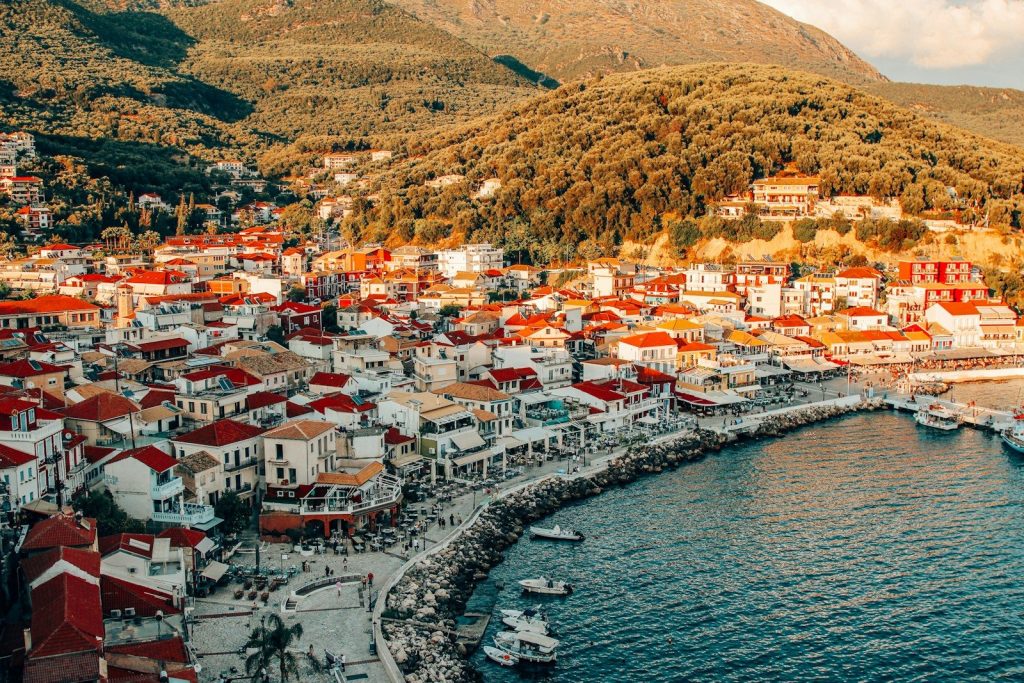 a view of a town on the shore of a body of water