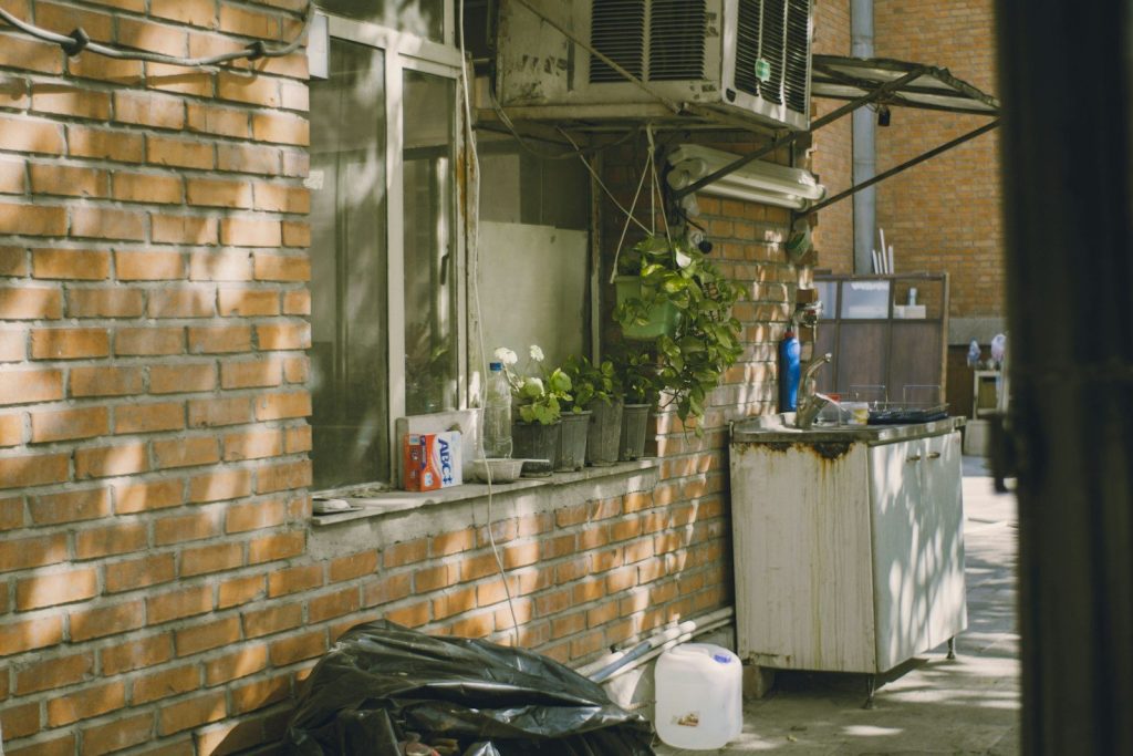 Outdoor area with brick wall and air conditioner.