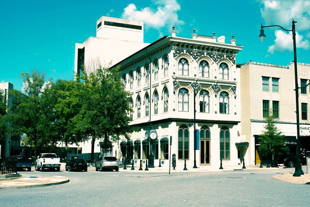A large white building sitting on the corner of a street