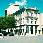 A large white building sitting on the corner of a street