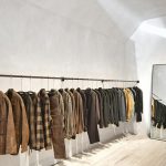 a room with a wall of clothes on the wall