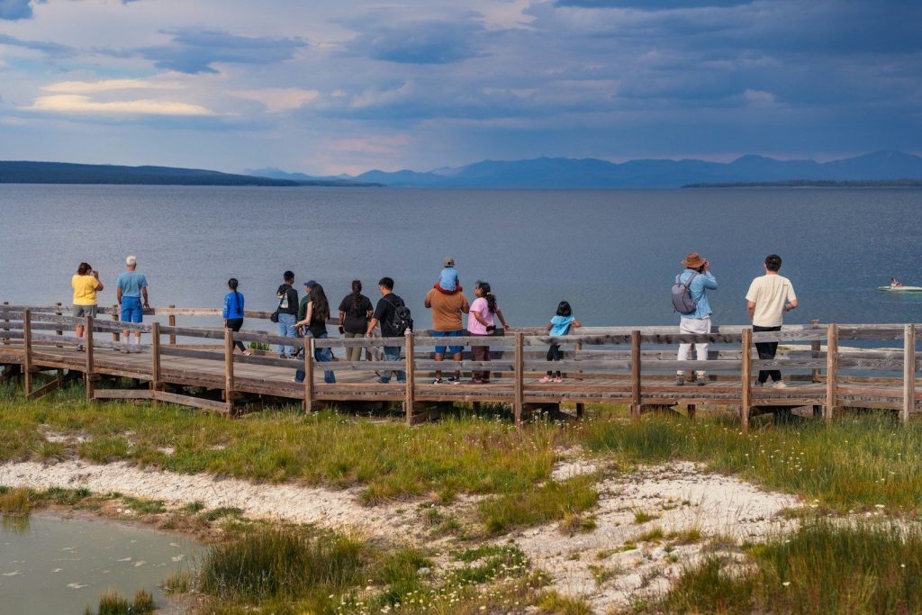 People on a boardwalk overlooking a large body of water