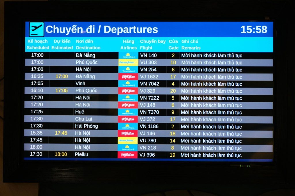 Airport departures board displaying flight information.