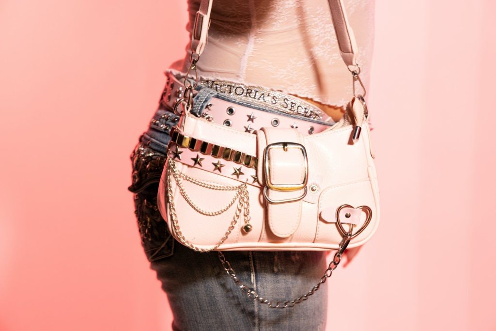 A pink purse with stars and chains
