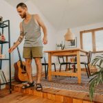 man standing near bookcase