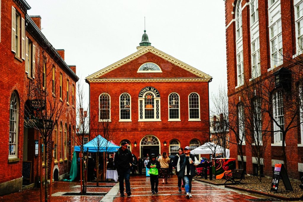 People walking in front of a red brick building