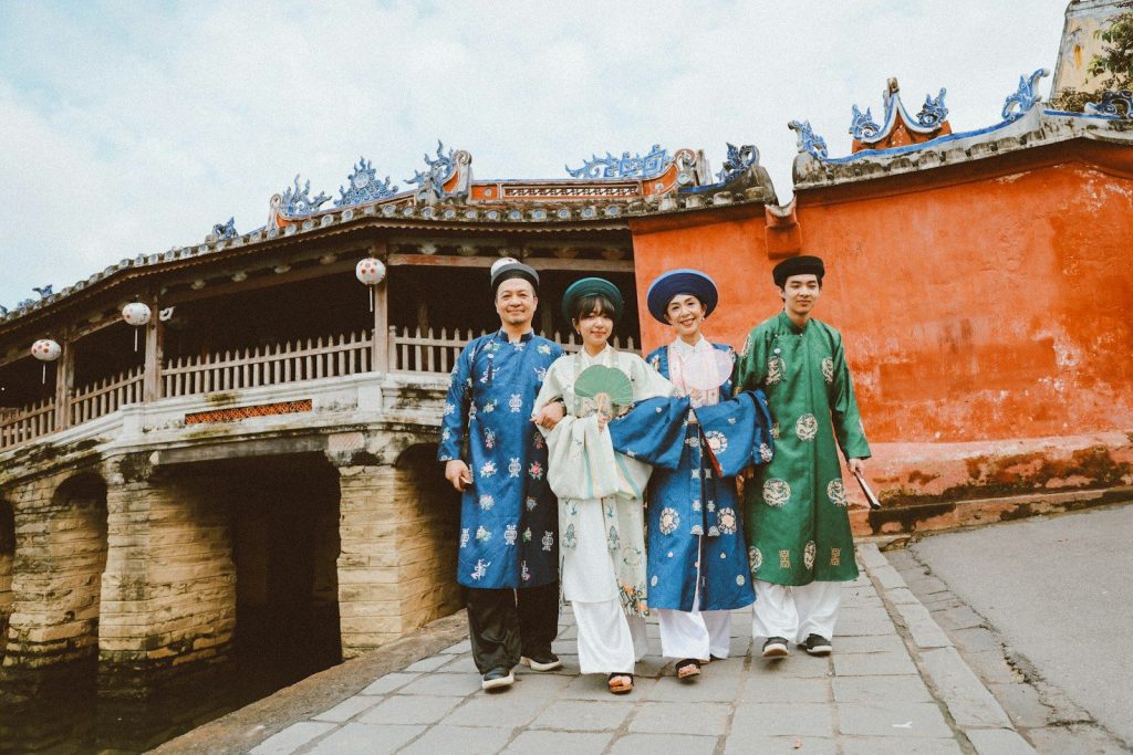 Four people in traditional vietnamese ao dai attire