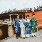 Four people in traditional vietnamese ao dai attire