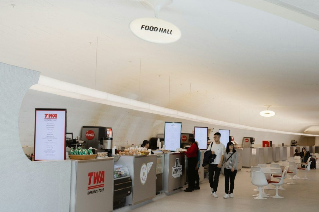 a group of people standing around a food court