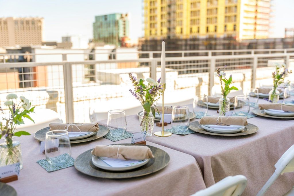 Rooftop dinner table is set, ready for guests.