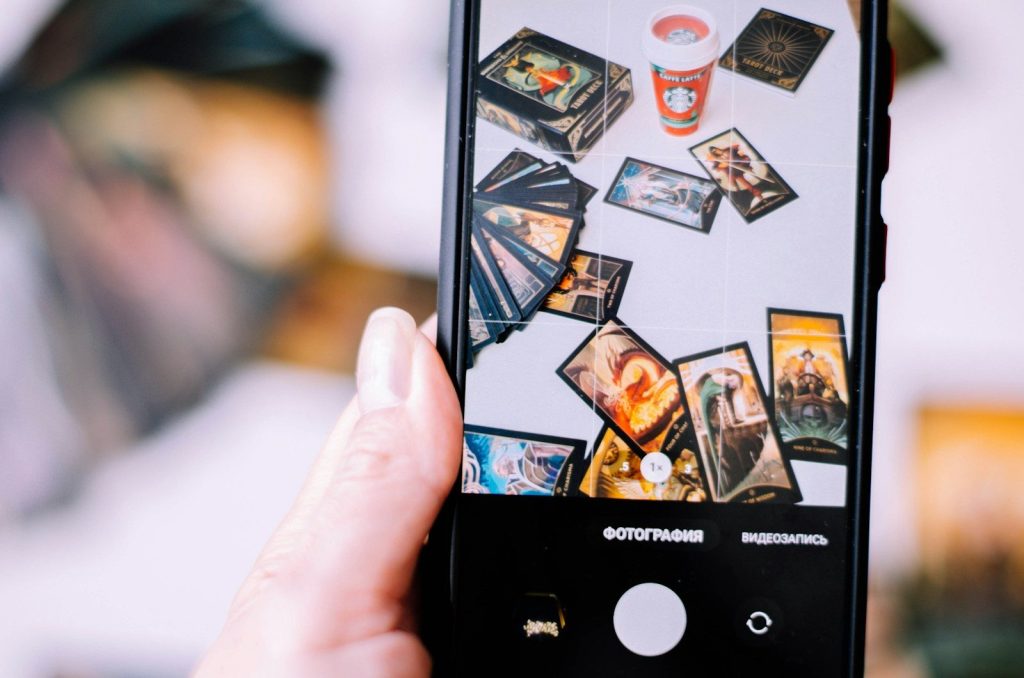 a person holding up a cell phone with pictures on it