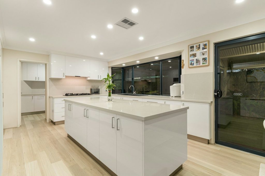 A large kitchen with a center island in the middle of the room