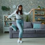 Young woman dancing while listening to music