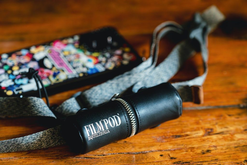 A flashlight and a cell phone on a table