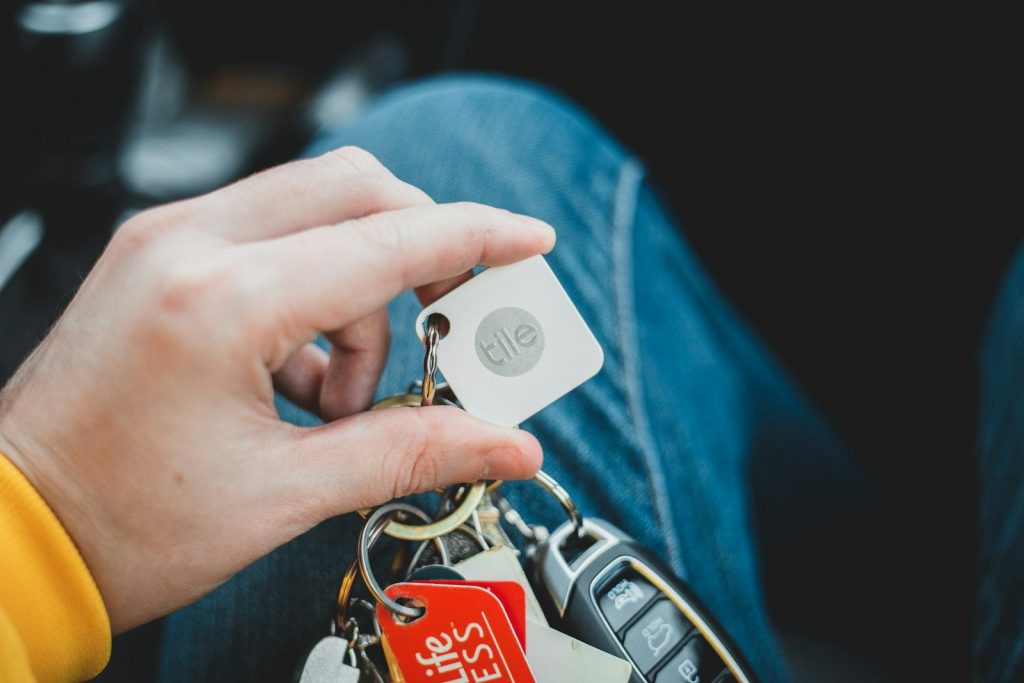 person holding silver and black key