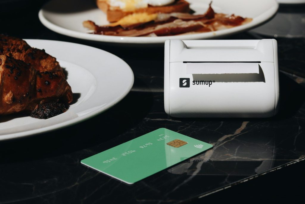 A table topped with plates of food and a credit card