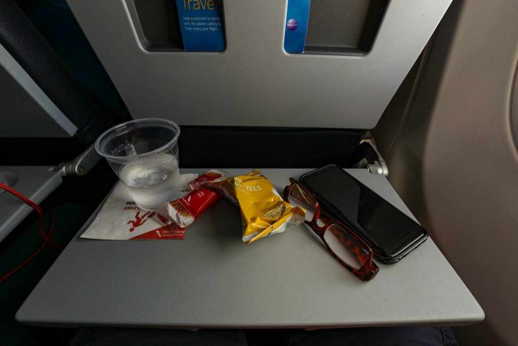 a table with a cell phone and some snacks on it
