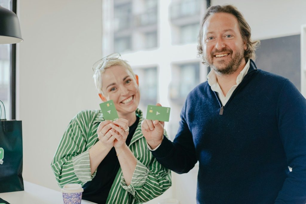 a man and a woman holding up small cards