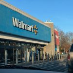 a walmart store with a car parked in front of it