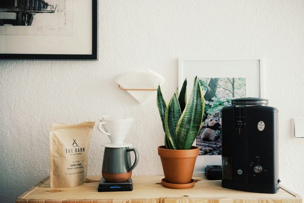 black ceramic mug beside black ceramic mug on brown wooden table